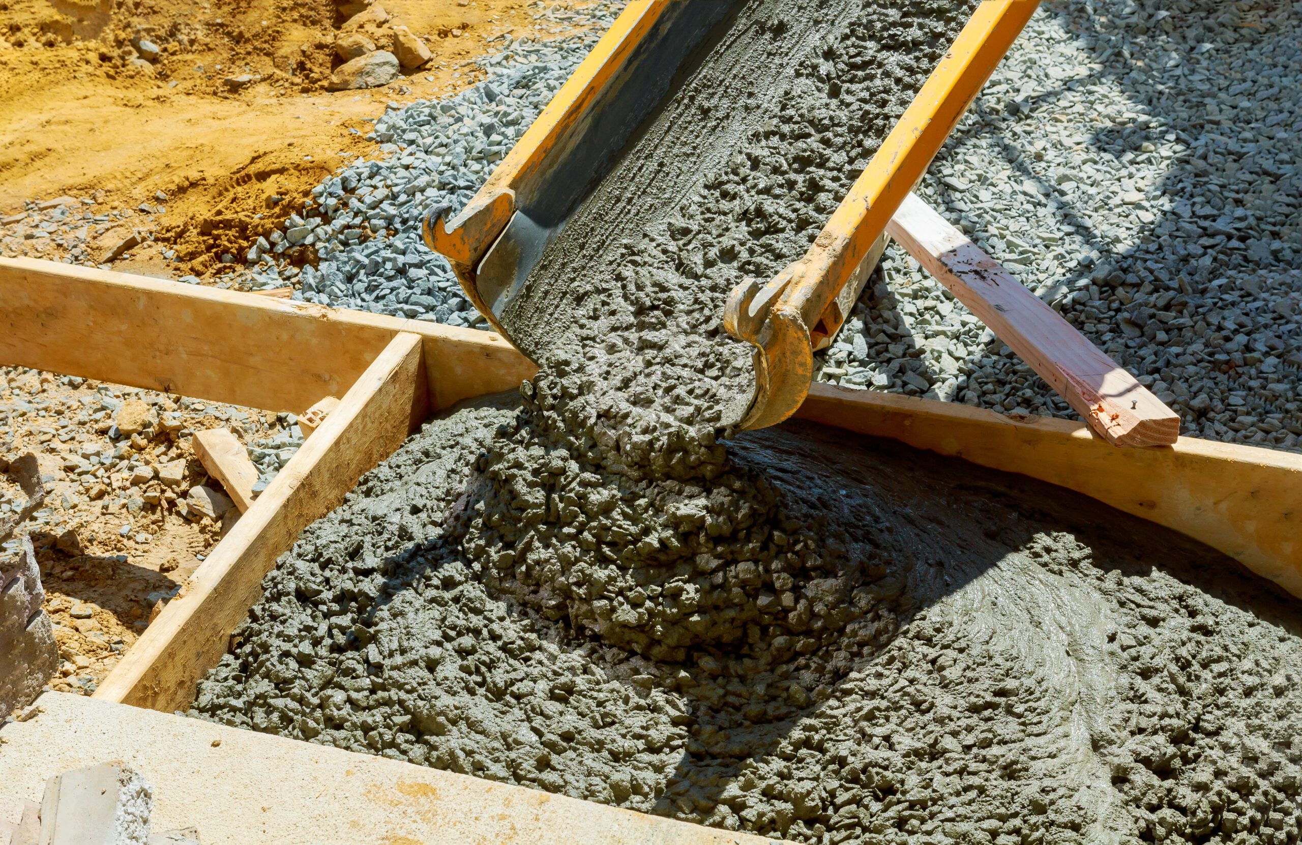 Construction of a concrete walkway around a residential rural house in manual of the pavement with a special tool